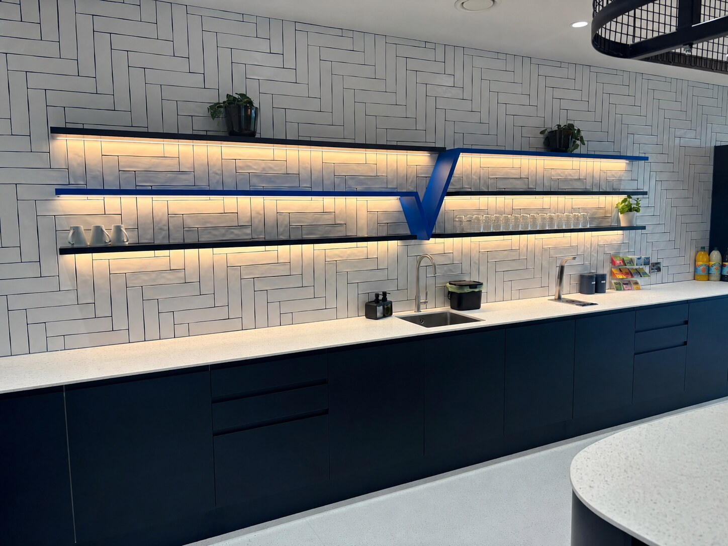 Completed illuminated office kitchen and breakout space
